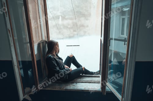Preview: beautiful woman poses on a window sill