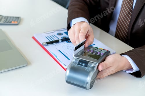 Preview: Close up. Payment using credit card swiping machine to pay