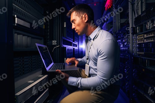 Preview: Serious focused system administrator checking data center equipment