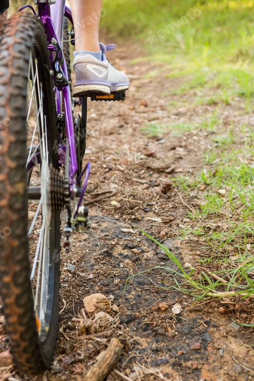 Preview: Close up view of woman pedaling on mountain bike in the nature