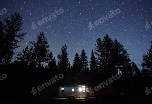 Preview: Starry night sky above a cozy camper setup in the wilderness
