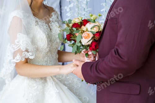 Preview: Beautiful wedding bouquet of flowers in the hands of the newlyweds