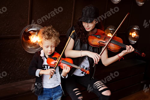 Preview: A young beautiful girl in black clothes sits next to her curly blonde with her son