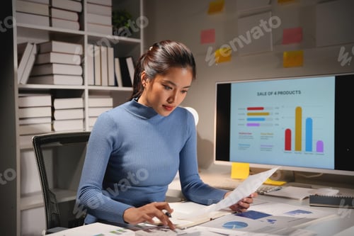 Preview: Young asian businesswoman is working late at night in her office