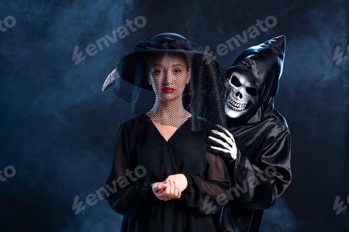 Preview: young female dressed in all black with hat on a dark background death funeral grim reaper