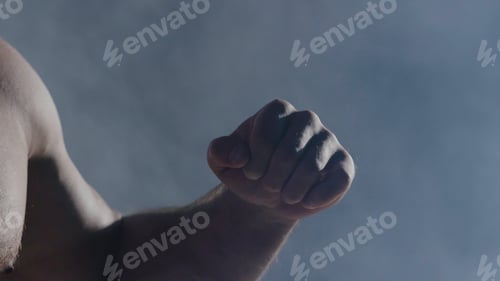 Preview: The man in boxing gloves. Young Boxer fighter over black background. Boxing man ready to fight