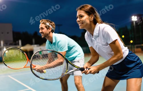 Preview: Beautiful young people are playing tennis as a team on tennis court outdoors. People sport concept