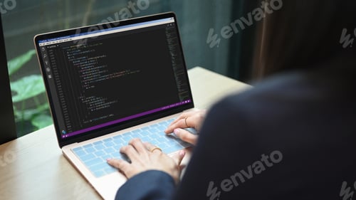 Preview: Female software developer on web site project, programming on desktop computer.