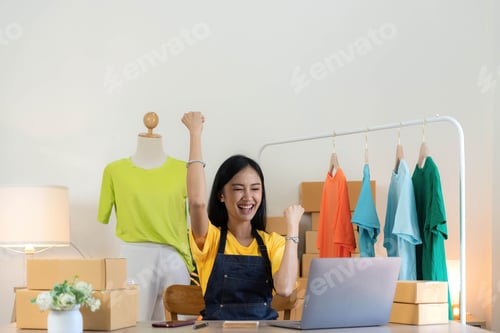 Preview: Startup small business entrepreneur SME, asian woman packing cloth in box. Portrait young Asian