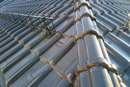 Preview: Closeup of house roof top covered with ceramic shingles. Tiled covering of building