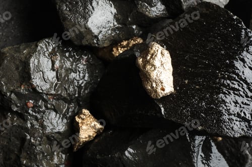 Preview: Shiny gold nuggets on wet stones, above view