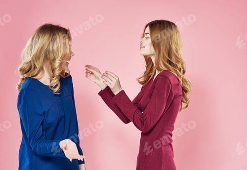 Preview: Two women socializing girlfriends lifestyle studio pink background