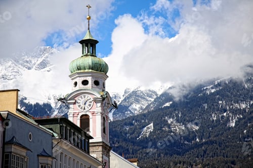 Preview: Church tower and background the snowy mountains of the city of Innsbruck. Austria