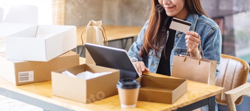 Preview: a young asian woman using tablet pc and credit card for online shopping