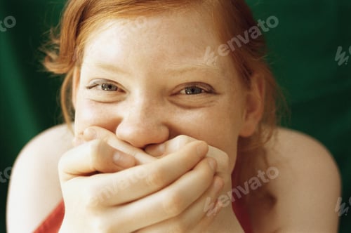 Preview: Girl laughing with hands over mouth