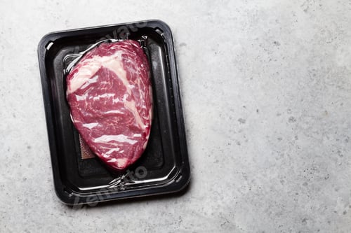 Preview: Vacuum packed beef steak. Raw ribeye steak