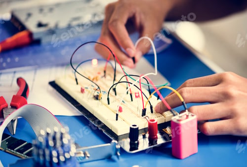 Preview: Closeup of hands working on breadboard