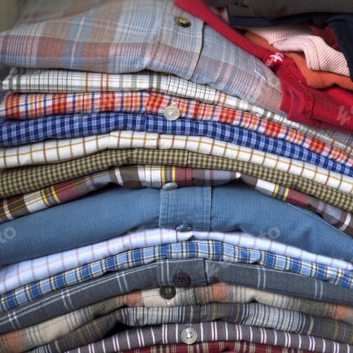 Preview: Neatly Folded Pile of Colorful Plaid Shirts