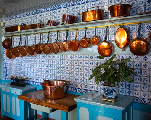 Preview: an old vintage kitchen with copper pots and pans with a blue tiled wall
