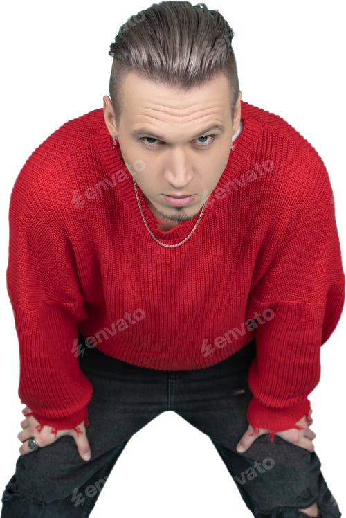 Preview: a man in a red sweater crouching down with his hands on his knees