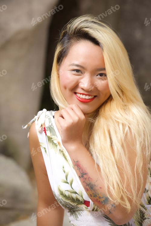 Preview: Smiling Woman with Blonde Hair Poses in Nature