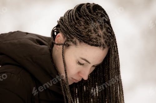 Preview: Young woman with African braids in natural winter environment landscape