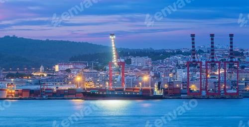 Preview: View of Lisbon port with ship and port cranes in the evening