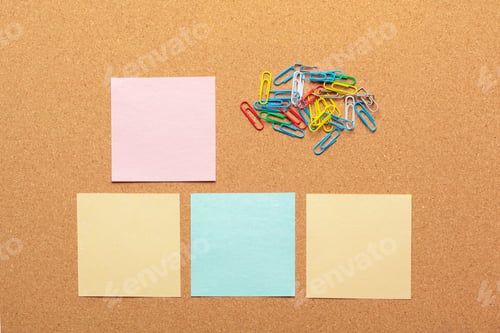 Preview: Sheet of paper for notes and paper clips on corkboard background
