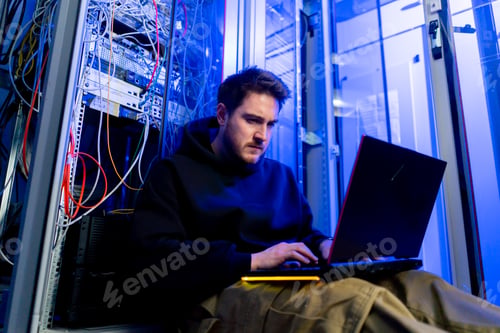 Preview: focused hacker in data center hacking software system vulnerable cyber security server room