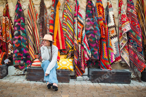 Preview: Old traditional Turkish carpet shop in cave house Cappadocia, Turkey Kapadokya. Young woman on
