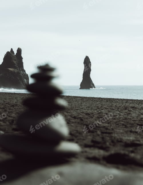 Preview: Majestic basalt rock of Reynisfjara emerging from the ocean, a wonder of Icelandic nature.