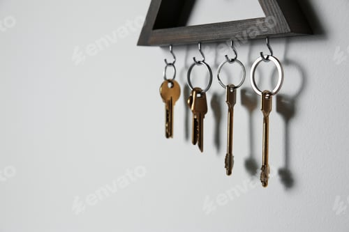 Preview: Wooden key holder on light grey wall. Space for text