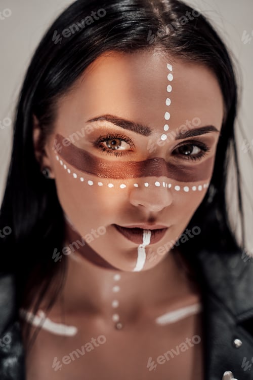 Preview: Close-up photo of a stylish girl with native American tribal make-up