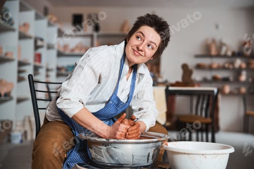 Preview: Cute brunette female person working in her workshop