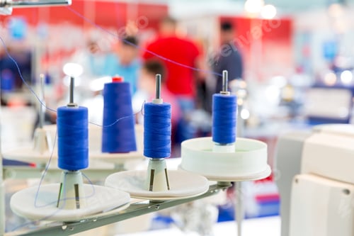 Preview: Spools of blue threads on sewing machine, closeup