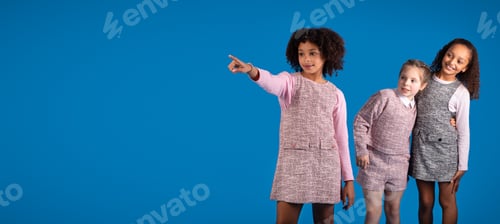Preview: Inspired glad multiracial little girlfriends in casual pointing fingers at copy space