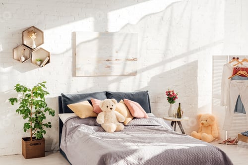 Preview: modern interior design of bedroom with teddy bear toys, pillows, plants and bed