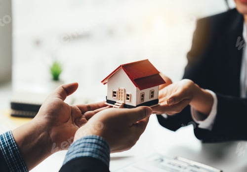Preview: Real Estate Broker Or businessman holding white house model in hand.Mortgage loan approval home loan
