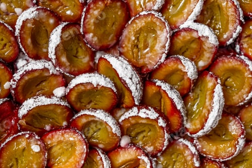 Preview: Tasty homemade pie or tart with plums and sugar powder. Close up shot