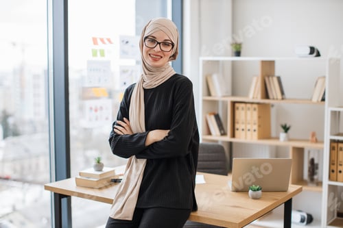 Preview: Business lady in hijab managing company in modern workplace