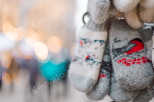 Preview: Christmas decoration at the Christmas market. Winter knitted mittens for hands with bullfinches bird
