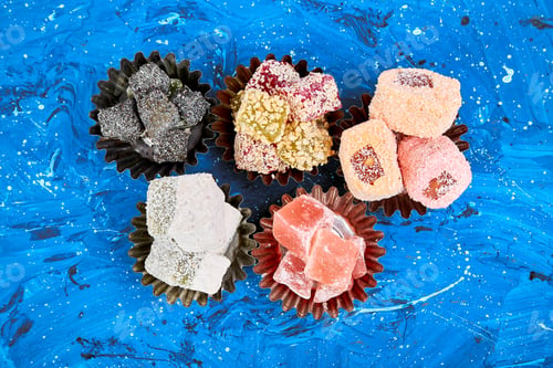 Preview: Set of various Turkish delight in bowl on blue background