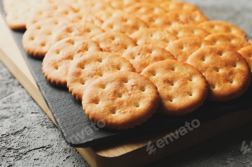 Preview: Board with cracker biscuits on gray background