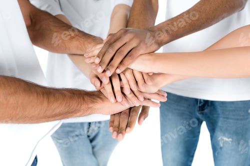 Preview: partial view of multiethnic friends in jeans joining hands isolated on white