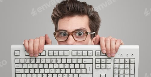 Preview: Man Holds Keyboard Hiding Behind Computer Technology
