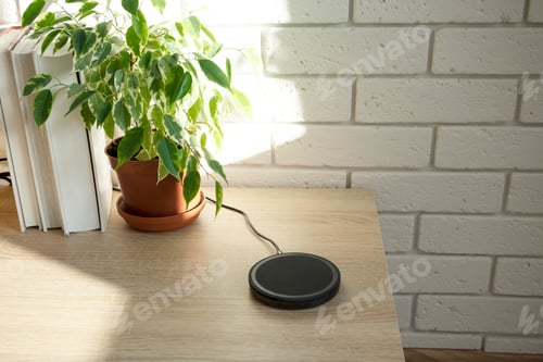 Preview: Charged wirelessly device at modern domestic room, indoors. Concept advanced technology