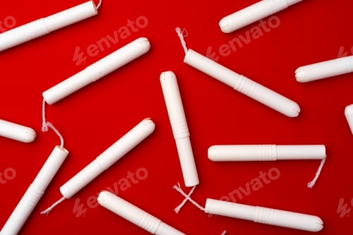 Preview: Pile of female tampons on red background
