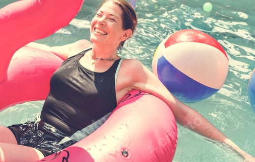 Preview: Woman enjoying the water in a swimming pool