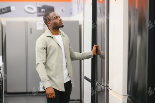 Preview: Customer choosing refrigerator in electronics store appliance section