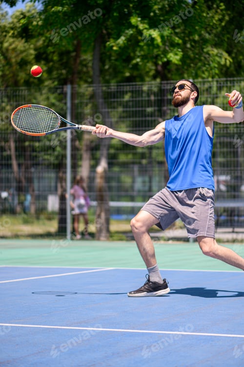 Preview: Young man playing tennis outdoor